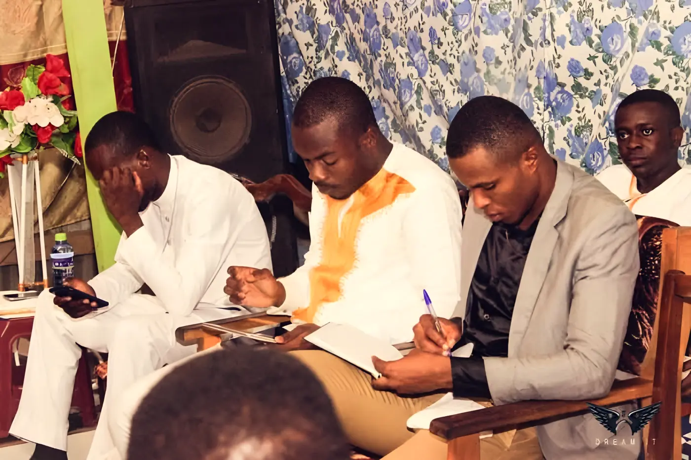 Young people taking notes during a BYM Bible study